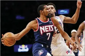  ?? MARY ALTAFFER - THE ASSOCIATED PRESS ?? Brooklyn Nets forward Kevin Durant (7) drives to the basket against Philadelph­ia 76ers forward Tobias Harris (12) during the second half of an NBA basketball game, Thursday, Dec. 16, 2021, in New York. The Nets won 114-105.