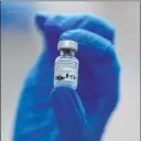  ?? Frank Augstein The Associated Press ?? A nurse holds a phial of the PfizerBion­tech COVID-19 vaccine at Guy’s Hospital in London on Tuesday.