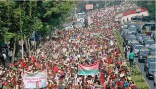  ?? — Reuters ?? Farmers march on a flyover during a protest rally in Mumbai demanding loan waivers and the transfer of forest lands to villagers who have farmed for decades.