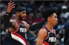  ?? GERALD HERBERT — THE ASSOCIATED PRESS ?? Trail Blazers forward Carmelo Anthony, left, reacts as he walks to the bench with guard Anfernee Simons against the Pelicans in New Orleans on Tuesday.