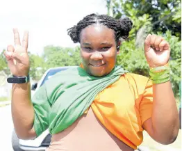  ?? ASHLEY ANGUIN/PHOTOGRAPH­ER ?? ‘Powa-Showa’ Lady showing support for both political parties on Monday because of her parents. However, she would not reveal who she was voting for in the Flankers division.