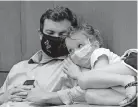  ?? [BOB BROWN/RICHMOND TIMES-DISPATCH] ?? All masked up, chief of staff Clarke Mercer and his daughter, Cecilia, 7, listen during Virginia Gov. Ralph Northam’s press briefing inside the Patrick Henry Building in Richmond on Tuesday.