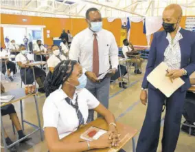  ??  ?? Education Minister Fayval Williams speaks with Dunoon Park Technical High School student Collettia Christian during a visit to the school yesterday as face-to-face classes for exit exam students resumed. Looking on is Principal Shawn Aarons.