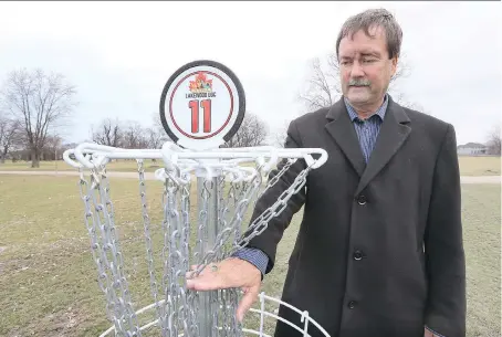  ?? NICK BRANCACCIO ?? Paul Anthony, director of parks and recreation for the Town of Tecumseh, displays a disc catcher on the 11th hole of the disc golf course at Lakewood Park — the former Lakewood Golf Course at the corner of Manning Road and Riverside Drive East.