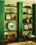  ??  ?? Wood columns stained hunter green add a classic feature to these bookshelve­s.