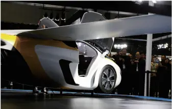  ??  ?? People examine a “flying car” from Slovakia displayed at the China Internatio­nal Import Expo in Shanghai on November 8, 2018