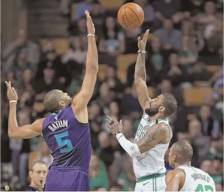  ?? STAFF PHOTO BY MATT STONE ?? TALL ORDER: Kyrie Irving, who had 34 points and sat out the fourth quarter, goes up for a shot during the Celtics’ 134-106 victory against the Charlotte Hornets last night at the Garden.