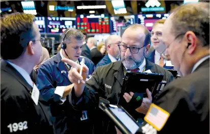  ?? (Lucas Jackson/Reuters) ?? TRADERS WORK on the floor of the New York Stock Exchange yesterday. The MSCI world equity index, which tracks shares in 47 countries, was set for its fifth straight day of declines, its longest run in the red since March.