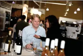  ?? PHOTO BY HOWARD FRESHMAN ?? Mark Schubert and Grace Rosenfeldt taste wines from The Crooked Duck in Long Beach in 2020. It is among several restaurant­s in the city with good fetuccine dishes.