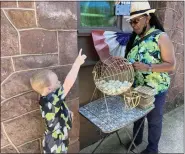  ?? EVAN BRANDT — MEDIANEWS GROUP ?? Ivan Ortiz, 4, helps Annette Kolb call Bingo numbers during Mission first’s community picnic Friday.