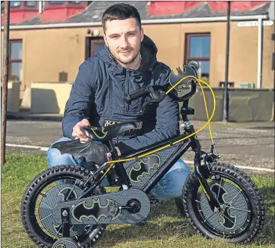  ??  ?? James Swankie with the working Batman Bike, secured with Raw Deal’s help, which his son now loves