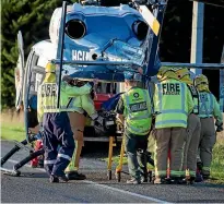  ??  ?? Two injured men are lifted into a rescue helicopter after the fatal crash.