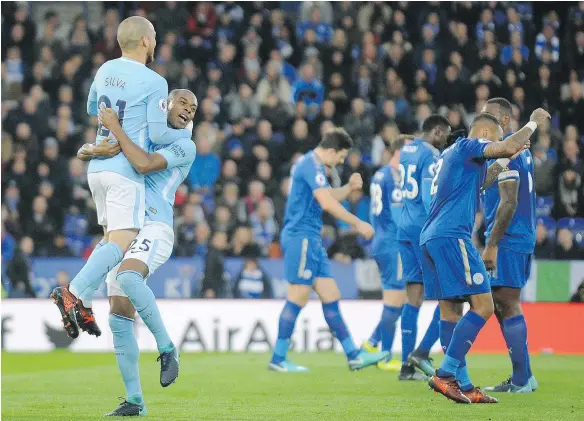  ?? — AP PHOTO ?? Manchester City’s David Silva celebrates with Fernandinh­o after his team scored against Leicester in an EPL game Saturday.