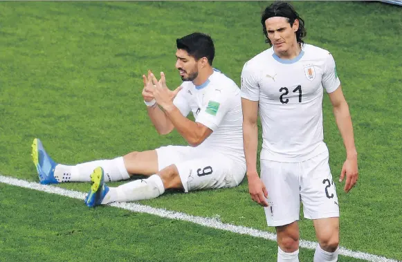  ?? HECTOR RETAMAL/AFP/GETTY IMAGES ?? Uruguay’s Luis Suarez, left, and Edinson Cavani react after missing a chance against Egypt in a 1-0 win at the World Cup on Friday in Sochi, Russia.