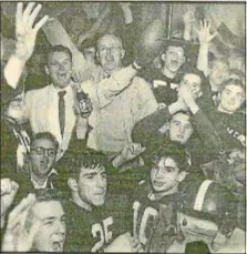  ?? DIGITAL FIRST MEDIA FILE PHOTO ?? Head coach Bean Brennan, holding hat, and assistant coach Joe Logue, with ball, celebrate with the 1953 St. James team after the Bulldogs won their first Catholic League championsh­ip.