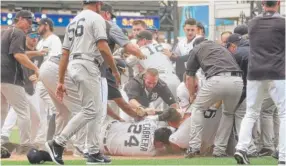  ??  ?? Tigers slugger Miguel Cabrera and Yankees catcher Austin Romine wrestle near home plate during a benches- clearing brawl in the sixth inning Thursday.
| GETTY MAGES