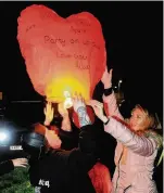  ??  ?? Happy birthday in heaven Courtney Lee and Connie Sloan send their lantern off in to the night sky high above the town