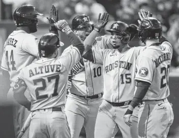  ?? Joshua Bessex / Associated Press ?? Martín Maldonado, who was 2 for 5, celebrates his grand slam with Yuli Gurriel (10), Chas McCormick (20), Yordan Alvarez (44) and Jose Altuve (27). It was the Astros’ first grand slam since Aug. 10, 2019.