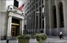  ?? SETH WENIG — THE ASSOCIATED PRESS FILE ?? A man walks toward the New York Stock Exchange.