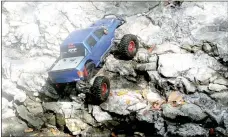  ?? Lynn Atkins/The Weekly Vista ?? Just like full-size rock crawlers, these radio-controlled scale models' suspension has an incredibly long range of travel.