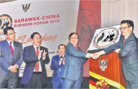  ??  ?? Abang Johari (second right) and Cheng shake hands after the launch of the Sarawak-China Business Forum in Kuching, as (from left) Abdul Karim, Wong and Naroden look on.