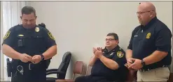  ??  ?? Cedartown Police Chief Jamie Newsome (left) talks about retired detective Jimmy Ray (right) during last week’s city commission meeting.