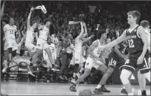  ?? The Associated Press ?? WOLVERINES WIN: Michigan players celebrate their emphatic 99-72 victory over Texas A&M Thursday in the NCAA Tournament West Region semifinal in Los Angeles.