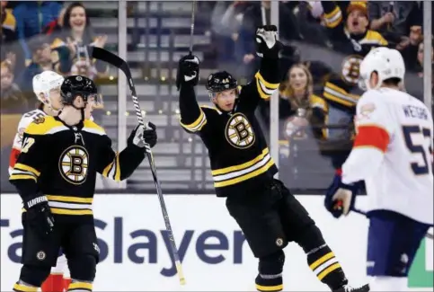  ?? ASSOCIATED PRESS ?? Boston Bruins’ Nick Holden (44) celebrates his goal with teammate Ryan Donato (17) during the first period of an NHL hockey game against the Florida Panthers in Boston, Saturday. The Bruins won 5-1.