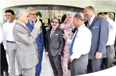  ?? — Bernama photo ?? Mahathir (second left) taking photo of Cabinet members during luncheon cruise on Putrajaya Lake yesterday.