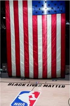  ?? AP Photo/Ashley Landis ?? Black Lives Matter is displayed near the NBA logo in an empty basketball arena on Friday in Lake Buena Vista, Fla.