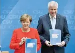  ?? — AFP ?? Angela Merkel, Chancellor and head of the Christian Democrats party, and Horst Seehofer, leader of Bavarian sister party CSU, present their parties’ electoral programmes in Berlin on Monday.