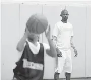  ??  ?? A former Willowridg­e star, Ford takes on students of any age at his basketball academy.