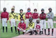  ??  ?? Jockeys line up ahead of the opening race of the new Qatar Racing & Equestrian Club’s (QREC) racing season at Al Rayyan on Wednesday.