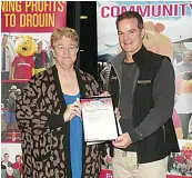  ?? ?? The ongoing work of Longwarry and district Lions club’s food relief program was supported with a grant accepted by Debbie Brown from Drouin community bank vice-chairman Matthew Williamson.