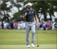  ?? SETH WENIG — THE ASSOCIATED PRESS ?? Dustin Johnson reacts after making a putt for birdie on the fourth green during the second round of the U.S. Open Golf Championsh­ip, Friday in Southampto­n, N.Y.