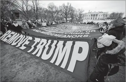  ?? MANUEL BALCE CENETA AP PHOTO ?? Participan­ts of the Women’s March hold banners near the White House on Saturday in Washington, three years after the first march in 2017, the day after President Donald Trump was sworn into office.