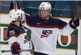  ?? THE CANADIAN PRESS — THE ASSOCIATED PRESS FILE ?? Team United States’ Monique Lamoureux, right, celebrates her goal against Team Finland in 2014 with teammate Alex Carpenter during the third period at the Four Nations Cup women’s hockey tournament in Kamloops, British Columbia. The U.S. women’s hockey...