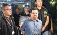  ?? PROVIDED TO CHINA DAILY ?? Police officers arrest Democratic Party member Howard Lam Tsz-kin in the early hours of Tuesday, accusing him of misleading police by providing false informatio­n.