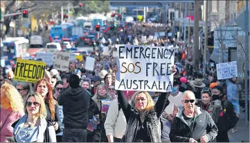  ?? REUTERS ?? Protesters march through the city centre during an anti-lockdown rally as an outbreak of Covid-19 affects Sydney, Australia,