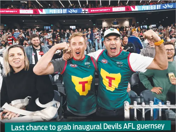  ?? Picture: Getty Images ?? Tasmania Devils fans Bradley Cox-Goodyear and Will Tatchell in their guernseys at the match between the Saints and the Magpies last month.