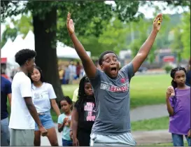  ?? NWA Democrat-Gazette/ANDY SHUPE ?? Collin Tims, 13, of Fayettevil­le reacts Saturday while throwing a ball at a University of Arkansas Police Department dunk tank during the celebratio­n.