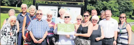  ??  ?? ■ Pictured with the Green Flag Award are representa­tives from Charnwood Borough Council, idverde and Friends of Queen’s Park.