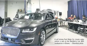  ??  ?? A self driving Ford Motor Co. Lincoln sedan vehicle is seen at the Blackberry Ltd. QNX headquarte­rs in Ottawa. — Bloomberg photo