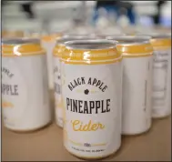  ?? (NWA Democrat-Gazette/Andy Shupe) ?? Empty cans for Black Apple pineapple cider sit before being filled Tuesday in Springdale.