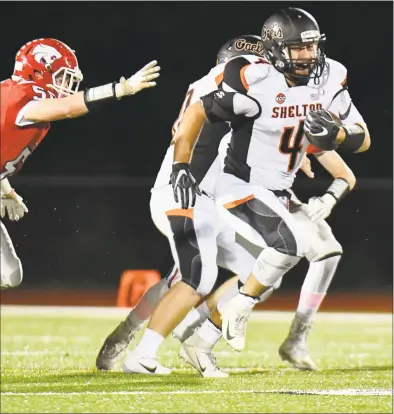  ?? Gregory Vasil / For Hearst Connecticu­t Media ?? Shelton’s Georgio Ghazal (4) carries the ball for a big gain against Masuk on Friday at Masuk High School in Monroe. Shelton won 38-10.