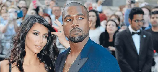  ??  ?? Now he ain’t sayin’ she a gold digger . . . but rapper Kanye West reportedly did get a prenup when he married reality TV star Kim Kardashian last year.