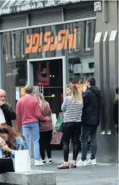  ??  ?? ■ Customers queue to get into Yo! Sushi in