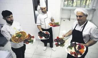  ??  ?? Chefs serve Şanlıurfa’s rich cuisine.