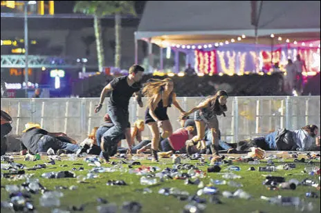  ?? AFP ?? People scramble for cover after hearing gunshots at the Route 91 Harvest country music festival in Las Vegas, Nevada, on Sunday.