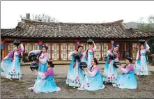  ?? CHEN JUNQING / XINHUA ?? From left: Villagers stage a traditiona­l Korean dance in Bailong village in Tumen, Jilin province.